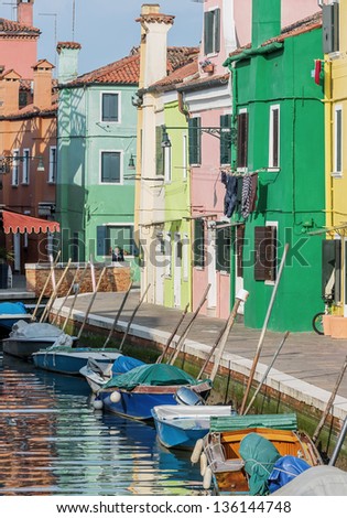 The multi-colored houses on the shore of a channel - Burano, Venice, Italy