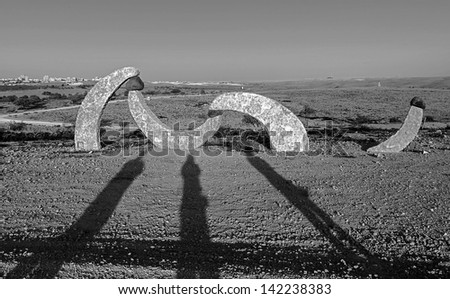 BEER SHEVA, ISRAEL - AUGUST 27:  The shadow of three photographers. The sculptures have been restored in the park near Beer Sheve August 27, 2012 in Israel (black and white)
