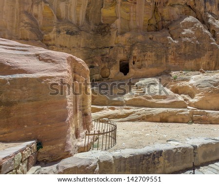 One of the tombs in the canyon of the Sig (Kings Way) - narrow passage to ancient city Petra, Jordan