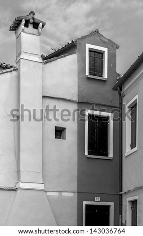 The colored houses on the shore of the channel - Burano, Venice, Italy (black and white)