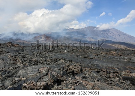 Active lava fields on the slopes of volcanoes Tolbachik, on background volcano Ostry Tolbachik (left) and Plosky Tolbachik - Kamchatka, Russia