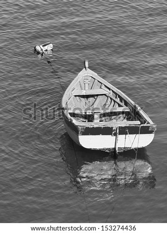 Small fishing boat floating in the fish port of Cascais - Portugal (black and white)