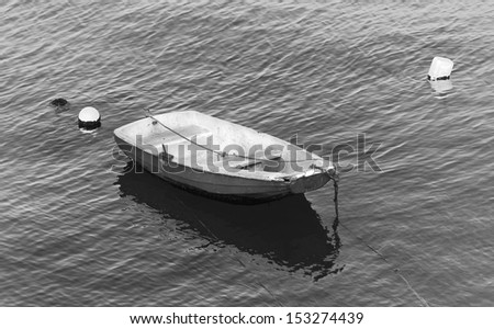 Small fishing boat floating in the fish port of Cascais - Portugal (black and white)