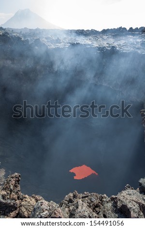 The boiling magma flows through lava tubes under a layer of cooled lava - volcano Tolbachik, Kamchatka, Russia