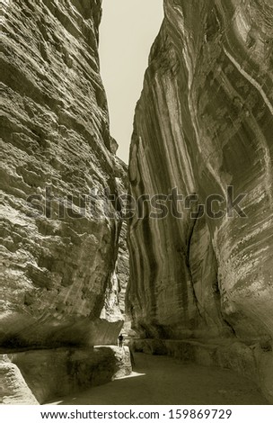 Colored walls in the canyon of the Sig (Kings Way) - narrow passage to ancient city Petra, Jordan (stylized retro)