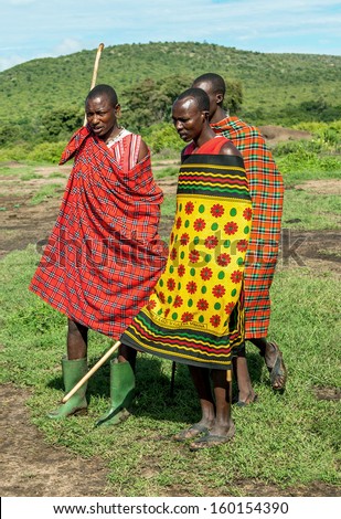 MASAI MARA, KENYA - DECEMBER 2: Masai warriors dancing traditional jumps as cultural ceremony. As well as their women sing and dance. Masai Mara National Park, December 2, 2011 in Kenya