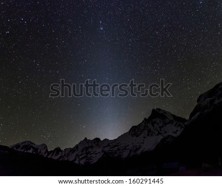 Zidiacal light and starry sky on background Machhapuchre and Annapurna Base Camp - Nepal