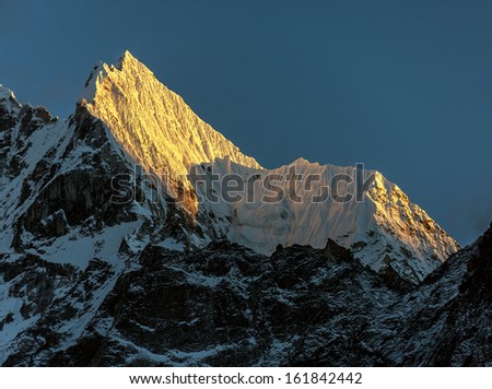 Peaks Kantega (6783 m) and Thamserku (6608 m) in the last light of the Sun (view from Tengboche monastery) - Everest region, Nepal, Himalayas