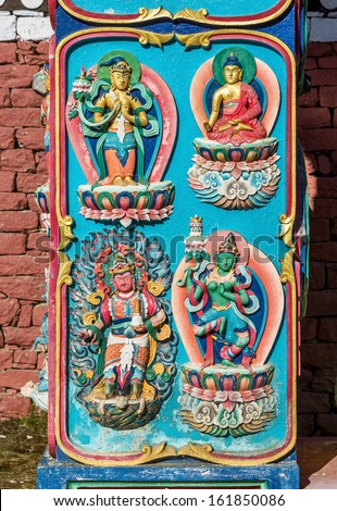 TENGBOCHE, NEPAL - OCTOBER 30: Bas-relief image of Buddhist gods on the columns of the main gate of the Tengboche monastery.  Khumbu region on October 30, 2012 in Tengboche
