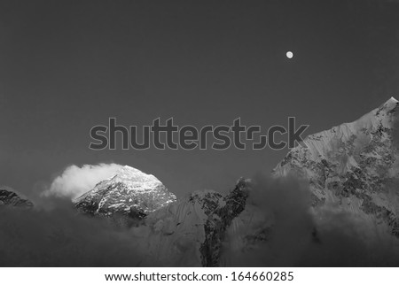 The Moon, Mt. Everest (8848 m), and slope of the Nuptse (7864 m) at sunset (view from Kala Patthar) - Nepal, Himalayas (black and white)