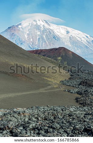 The active lava flow from a new crater on the slopes of volcanoes Tolbachik, on background volcanoes Ostry Tolbachik - Kamchatka, Russia
