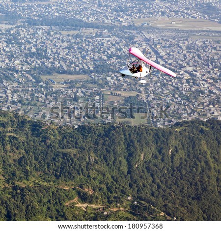 Motor hang-gliding in flight over the city of Pokhara - Nepal, Himalaya