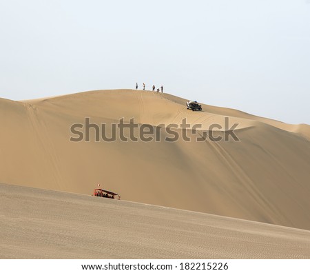 Tourists travel through the dunes in the Atacama Desert - Oasis of Huacachina, Peru, South America