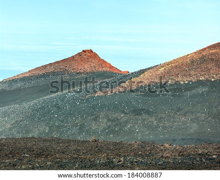 Old ruined volcanic cone covered with ash from an erupting volcano Tolbachik - Kamchatka, Russia