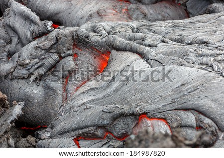 Molten lava flows on the surface of the cracks in the previously cooled lava - volcano Tolbachik, Kamchatka, Russia