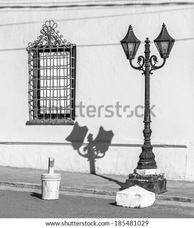 Old Lantern and its shadow on the wall in a sunny day - Puno, Lake Titicaca, Peru, South America (black and white)