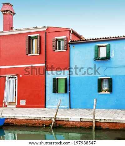 The colored houses on the shore of a narrow channel the Island of Burano - Venice, Italy