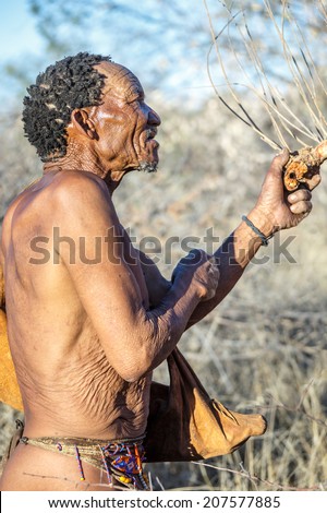 BUITEROS, NAMIBIA - JULY 17, 2014: Hunter Bushmen posing tourists. The San people, also known as Bushmen are members of various indigenous hunter-gatherer peoples of Southern Africa.