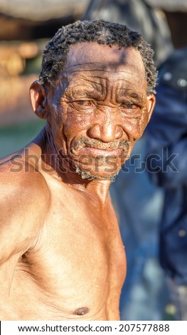 BUITEROS, NAMIBIA - JULY 17, 2014: Close-up portrait hunter Bushman. The San people, also known as Bushmen are members of various indigenous hunter-gatherer peoples of Southern Africa