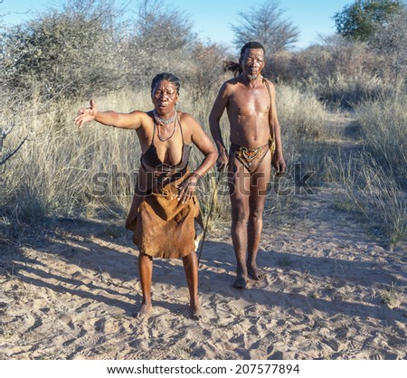 BUITEROS, NAMIBIA - JULY 17, 2014: Hunter Bushmen and their wives posing tourists. The San people, also known as Bushmen are members of various indigenous hunter-gatherer peoples of Southern Africa.