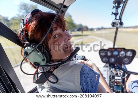 A young woman in the cabin of the helicopter before flying above the Victoria Falls, Zambia