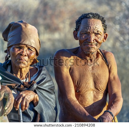 BUITEROS, NAMIBIA - JULY 17, 2014: Hunter Bushmen and their wives posing tourists. The San people, also known as Bushmen are members of various indigenous hunter-gatherer peoples of Southern Africa.