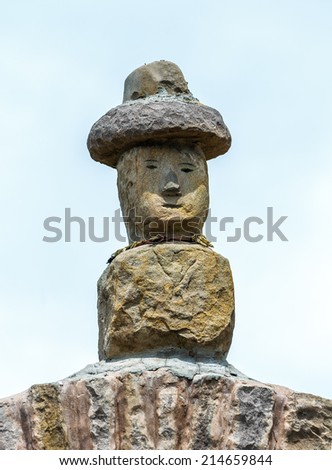 Traditional sculpture standing on a Rocky Arch on Taquile Island - Titicaca lake, Peru