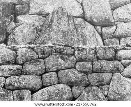 IWall in Inca city Machu Picchu at mist weather. It is a designated UNESCO World Heritage Site - Peru, South America (black and white)