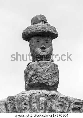 Traditional sculpture standing on a Rocky Arch on Taquile Island - Titicaca lake, Peru (black and white)