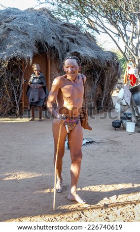 BUITEROS, NAMIBIA - JULY 17, 2014: Hunter Bushmen posing tourists. The San people, also known as Bushmen are members of various indigenous hunter-gatherer peoples of Southern Africa