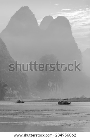 Misty morning on the river at sunrise - The Li River, Xingping, China (black and white)