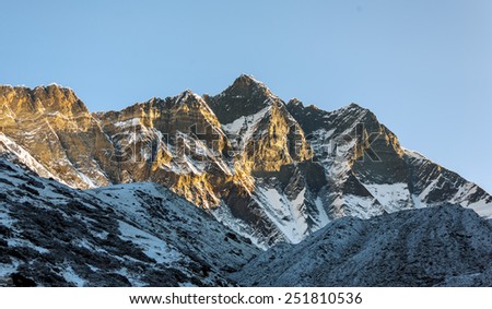 The first rays of the morning sun on the fourth in the world at the height of mount Lhotse (8516 m), view from the Chhukhung Ri - Everest region, Nepal