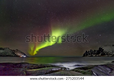 Aurora borealis (Polar lights). View to Steinfjord on Senja island (Oksan on background) - Norway
