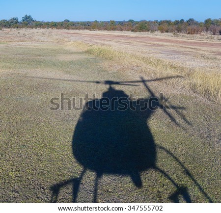 The shadow of the helicopter on the tarmac of a small airfield near Victoria falls - Livingstone, Zambia