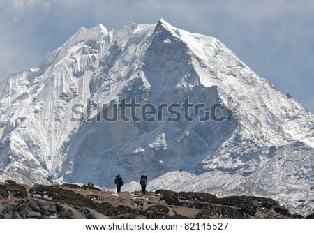Trekkers against of snow-covered Island peak (6189 m)  - Nepal, Himalayas