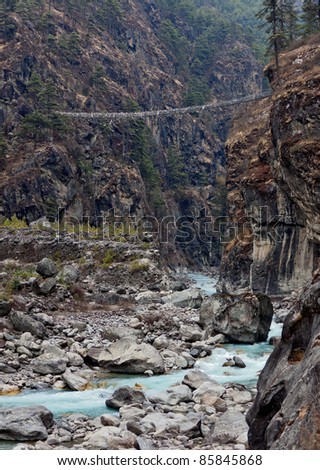 Suspension bridge across the river on the trail to Mt. Everest, Nepal