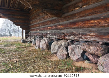 The lower tier and the foundation stones of old wooden church in Shirkovo - Russia