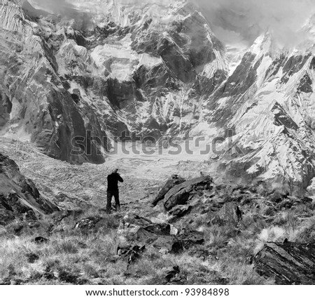 The photographer shooting Annapurnu from base camp (black and white) - Nepal