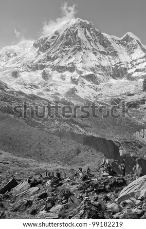 Tourists on the moraine of the glacier circus Annapurna (black and white) - Nepal, Himalayas