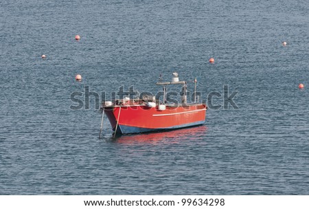 Small fishing boat floating in the fish port of Cascais - Portugal