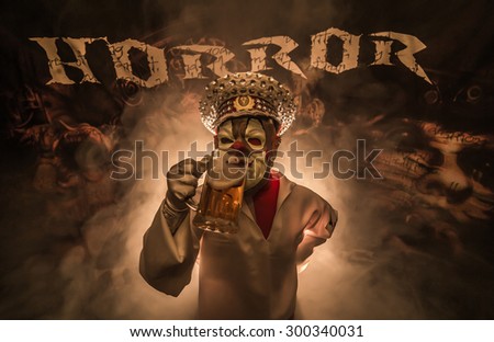 Man dressed as clown terrible captain with a mug of beer in his hand.