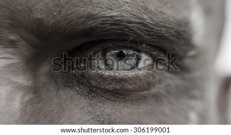 Macro man\'s eyes with pain and suffering in his eyes, the man in the mud.