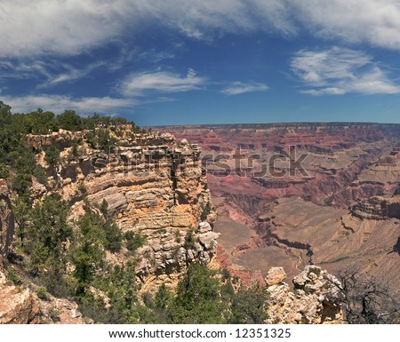 Tourists at the rim peer into the vastness of Grand Canyon