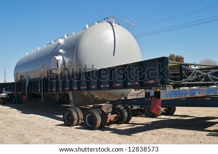 Oversize trailer with large storage tank.
