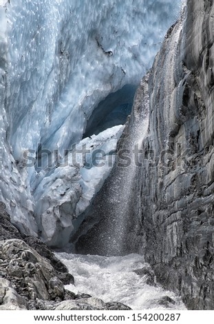 Close up of waterfall and glacier ice on Worthington Glacier in Alaska.