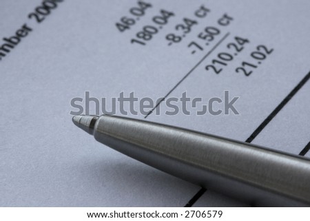 Close-up of pen on bank statement