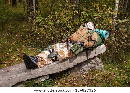 Soldier relaxing on reinforced concrete slab.