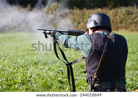 Spec ops soldier shooting shotgun.