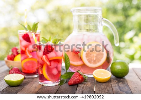 Pink lemonade with lemon, lime and strawberries