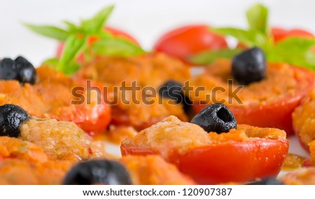 closeup of a black olives on a stuffed tomato